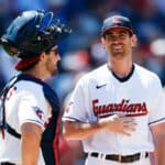 Shane Bieber #57 of the Cleveland Guardians talks with catcher Austin Hedges #17 after pitching a complete game 4-1 win against the Chicago White Sox in game one of a doubleheader at Progressive Field on July 12, 2022 in Cleveland, Ohio.