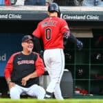 Terry Francona #77 celebrates with Andres Gimenez #0 of the Cleveland Guardians after Gimenez hit a solo homer during the fourth inning against the Boston Red Sox at Progressive Field on June 24, 2022 in Cleveland, Ohio.