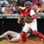Austin Hedges #17 of the Cleveland Guardians throws to first base after forcing out Jarren Duran #40 of the Boston Red Sox at home plate during the seventh inning at Progressive Field on June 25, 2022 in Cleveland, Ohio.