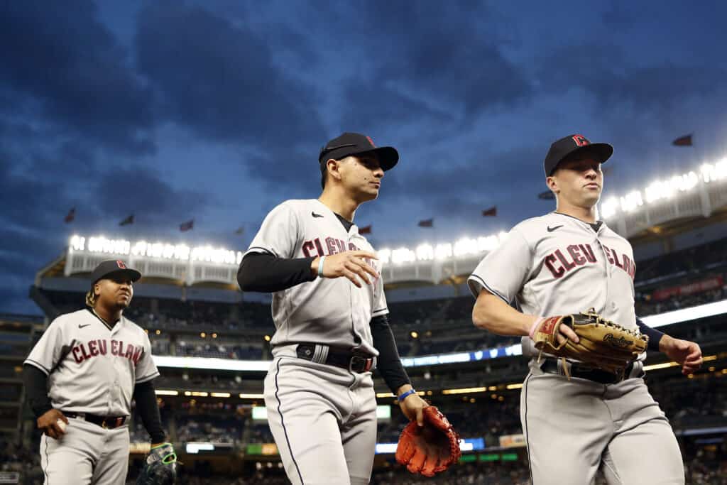 NEW YORK, NEW YORK - MAY 02: Will Brennan #17, Andres Gimenez #0, and Jose Ramirez #11 of the Cleveland Guardians walk to the dugout during the third inning against the New York Yankees at Yankee Stadium on May 02, 2023 in the Bronx borough of New York City.