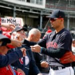 Andres Gimenez #0 of the Cleveland Guardians signs autographs before a spring training game against the San Francisco Giants at Goodyear Ballpark on March 02, 2023 in Goodyear, Arizona.