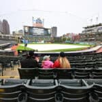 Fans linger in the stands after the game between the Cleveland Guardians and the Miami Marlins was postponed due to inclement weather at Progressive Field on April 21, 2023 in Cleveland, Ohio. A double header will be played tomorrow.