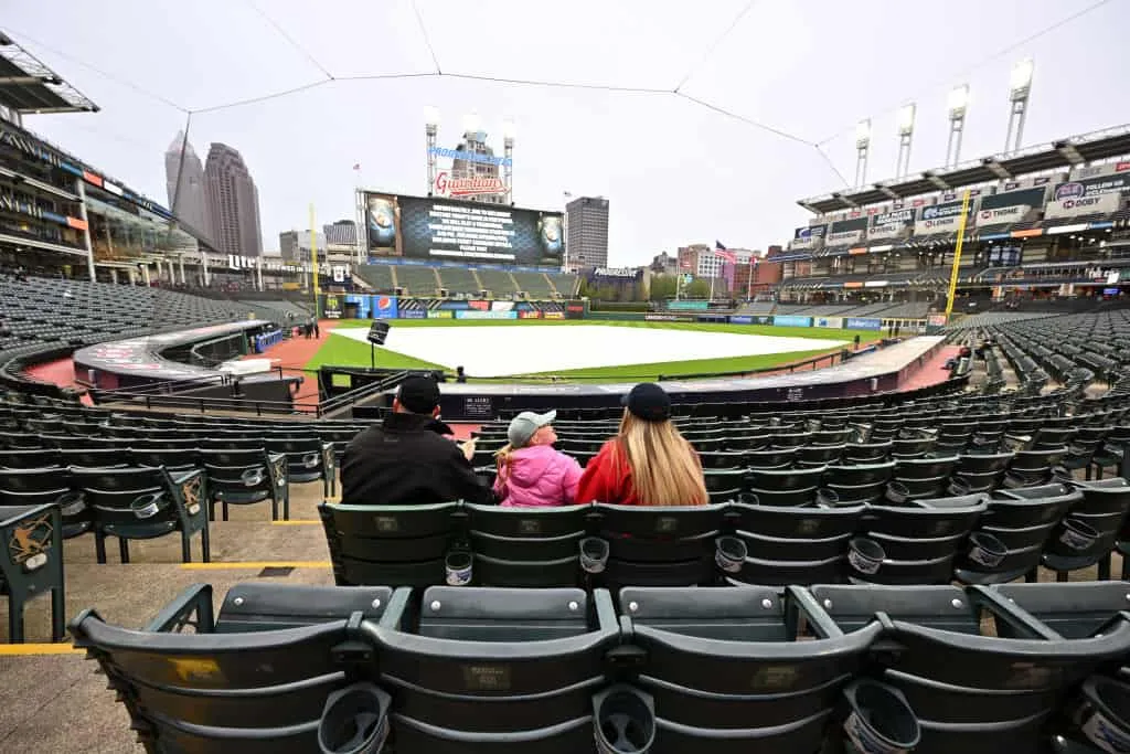 Fans linger in the stands after the game between the Cleveland Guardians and the Miami Marlins was postponed due to inclement weather at Progressive Field on April 21, 2023 in Cleveland, Ohio. A double header will be played tomorrow.