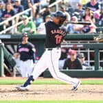 Jose Ramirez #11 of the Cleveland Guardians hits an RBI single against the Oakland Athletics during the fourth inning of a spring training game at Goodyear Ballpark on February 27, 2024 in Goodyear, Arizona.