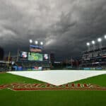 The rain tarp sits on the infield of Progressive Field during the third inning of the game between the Cleveland Guardians and the Los Angeles Dodgers on August 23, 2023 in Cleveland, Ohio. The game was suspended in the third inning.