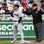 Steven Kwan #38 of the Cleveland Guardians gestures to teammates after hitting a double in the fifth inning of the the home opener against the Minnesota Twins at Target Field on April 4, 2024 in Minneapolis, Minnesota.
