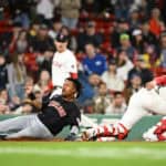 José Ramírez #11 of the Cleveland Guardians scores on a two-run single off the bat of Estevan Florial ahead of a tag by Connor Wong #12 of the Boston Red Sox in the 11th inning at Fenway Park on April 16, 2024 in Boston, Massachusetts. The Guardians won 10-7.