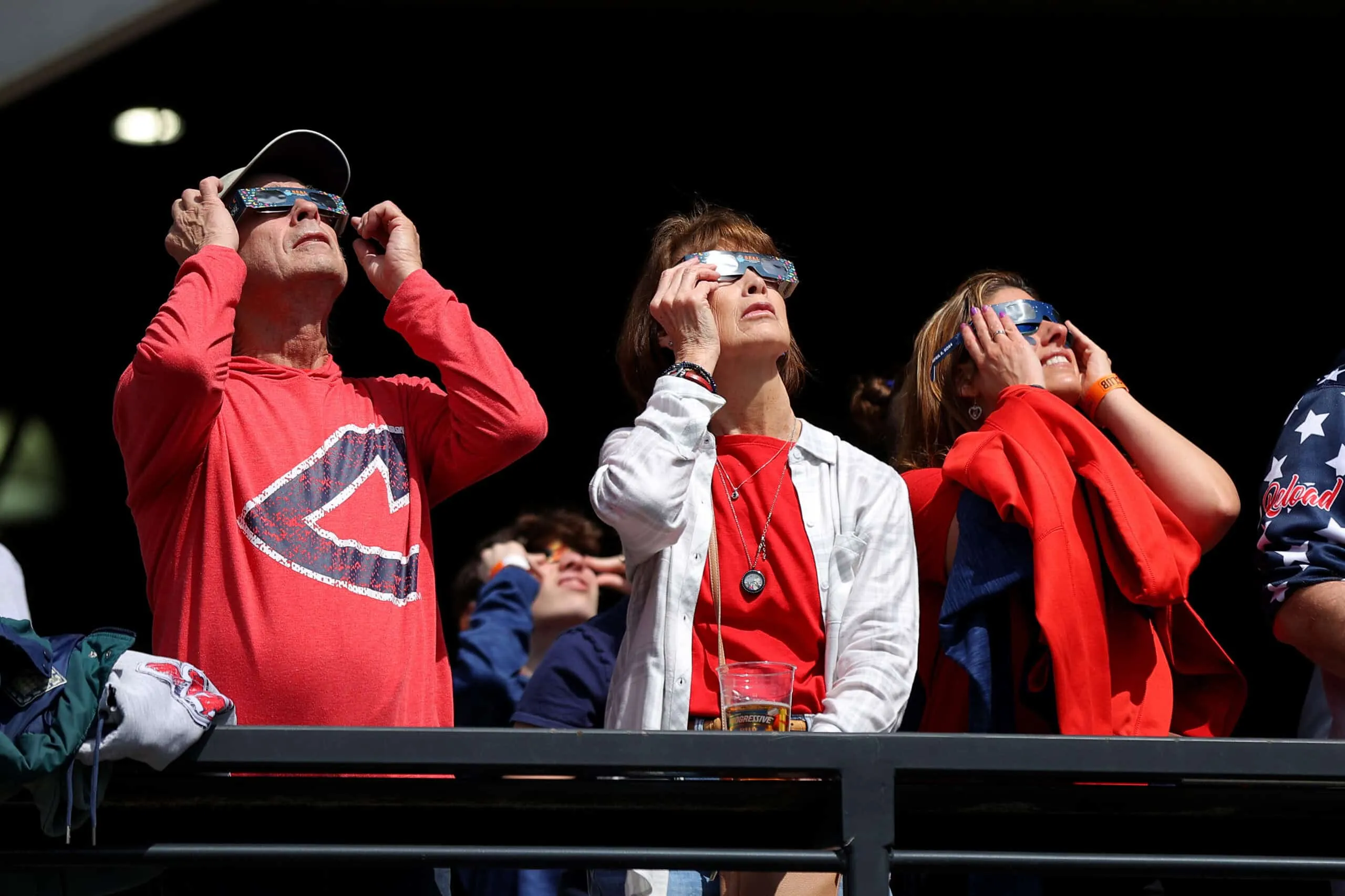 CLEVELAND, OHIO - APRIL 08: Cleveland Guardians fans look up at the solar eclipse before the home opener against the Chicago White Sox at Progressive Field on April 08, 2024 in Cleveland, Ohio. Cleveland is in the "path of totality" for today's total solar eclipse.