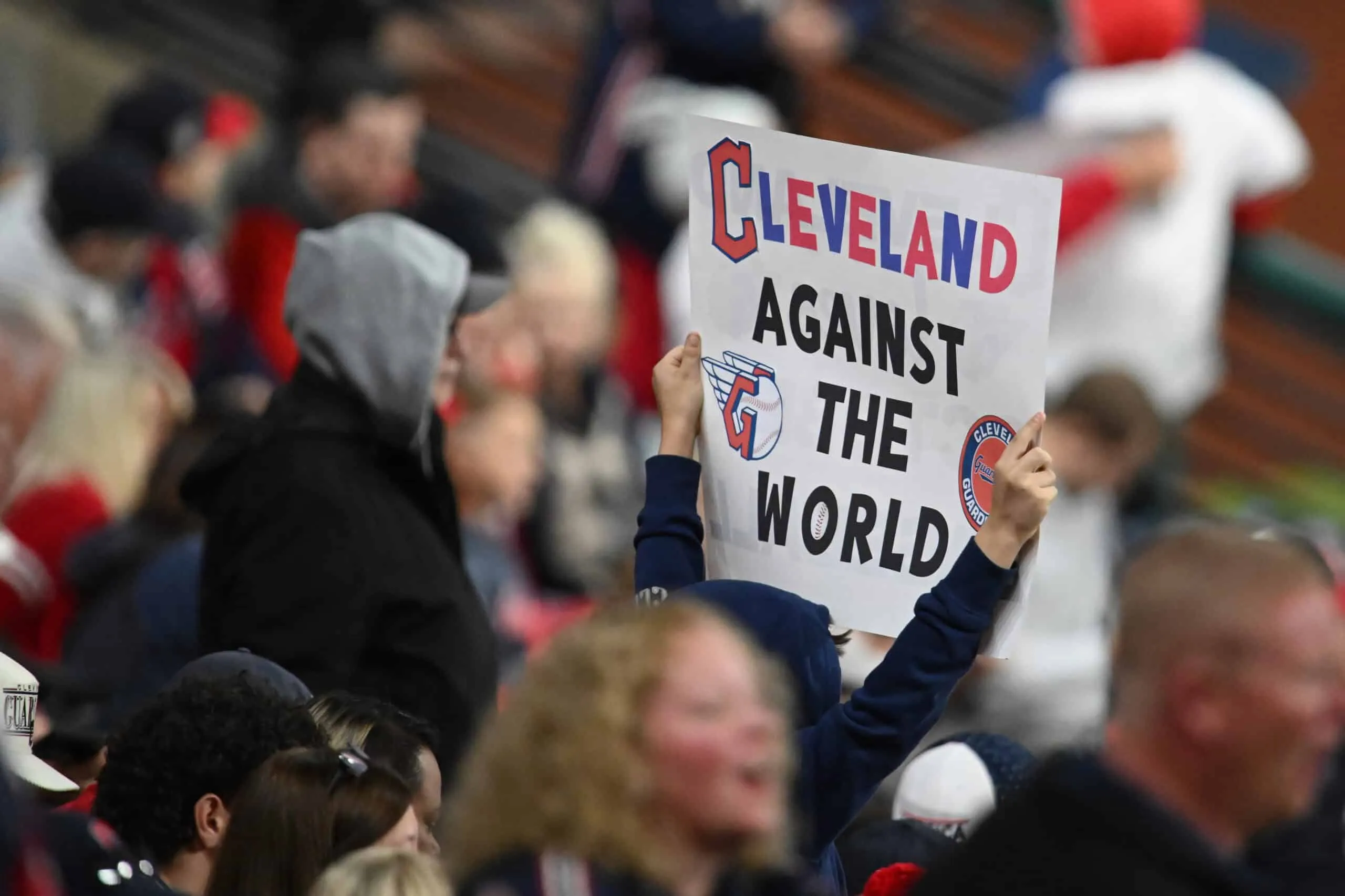 CLEVELAND, OHIO - OCTOBER 19: A fan holds a sign before Game Five of the American League Championship Series between the New York Yankees and Cleveland Guardians at Progressive Field on October 19, 2024 in Cleveland, Ohio.