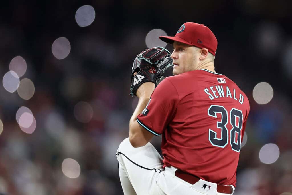 PHOENIX, ARIZONA - JULY 11: Relief pitcher Paul Sewald #38 of the Arizona Diamondbacks throws a warm-up pitchduring ninth inning of the MLB game against the Atlanta Braves at Chase Field on July 11, 2024 in Phoenix, Arizona. The Diamondbacks defeated the Braves 1-0.