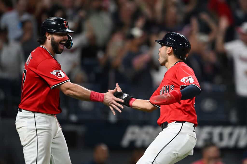 CLEVELAND, OHIO - SEPTEMBER 23: Austin Hedges #27 and Steven Kwan #38 of the Cleveland Guardians celebrate scoring on a single hit by Daniel Schneemann during the seventh inning against the Detroit Tigers at Progressive Field on September 23, 2025 in Cleveland, Ohio.