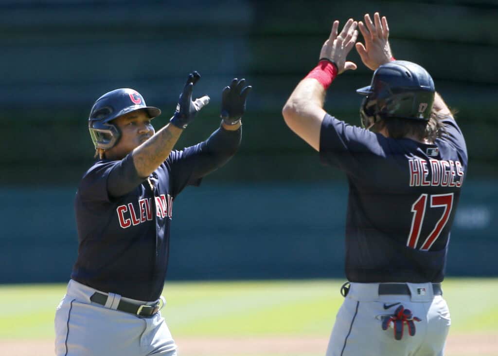DETROIT, MI - AUGUST 15: Jose Ramirez #11 of the Cleveland Indians celebrates with Austin Hedges #17 after hitting a two-run home run that scored the pair against the Detroit Tigers during the second inning at Comerica Park on August 15, 2021, in Detroit, Michigan.