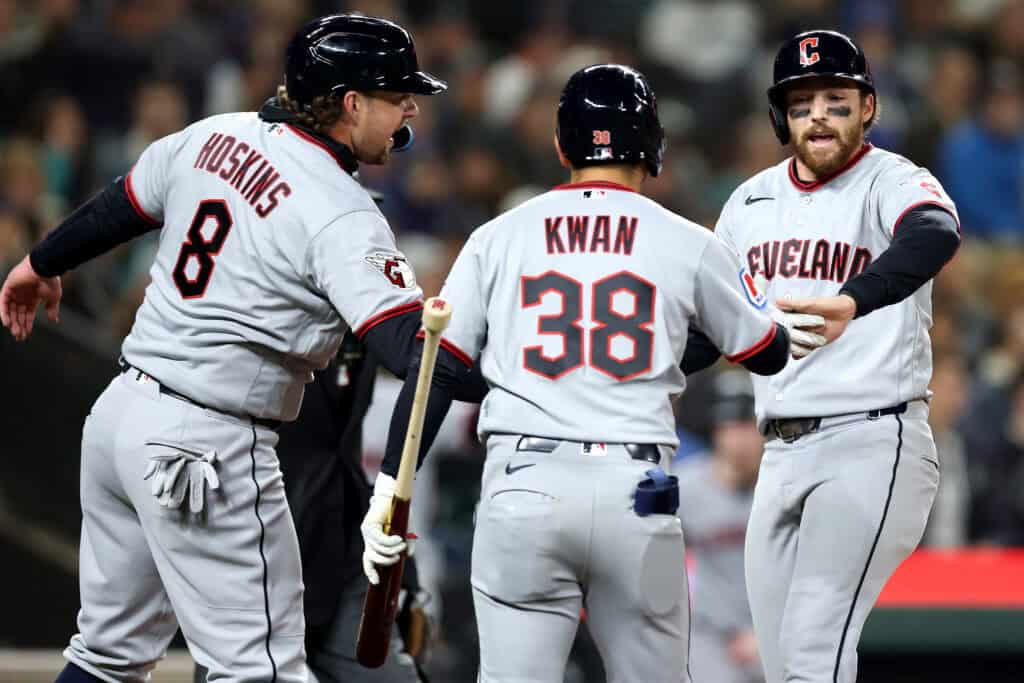 SEATTLE, WASHINGTON - MARCH 26: Rhys Hoskins #8, Steven Kwan #38 and Daniel Schneemann #10 of the Cleveland Guardians celebrate runs after an RBI double by Brayan Rocchio #4 (not pictured) during the fifth inning against the Seattle Mariners at T-Mobile Park on March 26, 2026 in Seattle, Washington.