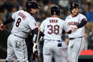 SEATTLE, WASHINGTON - MARCH 26: Rhys Hoskins #8, Steven Kwan #38 and Daniel Schneemann #10 of the Cleveland Guardians celebrate runs after an RBI double by Brayan Rocchio #4 (not pictured) during the fifth inning against the Seattle Mariners at T-Mobile Park on March 26, 2026 in Seattle, Washington.