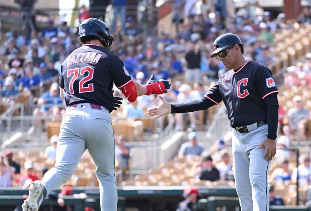GLENDALE, ARIZONA - FEBRUARY 24: Travis Bazzana #72 of the Cleveland Guardians celebrates with third base coach Rouglas Odor #53 after hitting a three run home run against the Los Angeles Dodgers during the second inning of a spring training game at Camelback Ranch on February 24, 2026 in Glendale, Arizona.