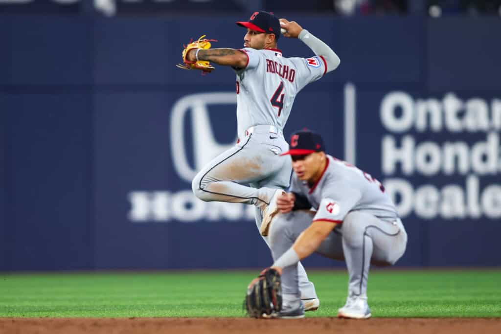 TORONTO, CANADA - APRIL 25: Brayan Rocchio #4 of the Cleveland Guardians looks to turn a double play after forcing out Myles Straw #3 of the Toronto Blue Jays at second base in the third inning of their MLB game at Rogers Centre on April 25, 2026 in Toronto, Ontario, Canada.