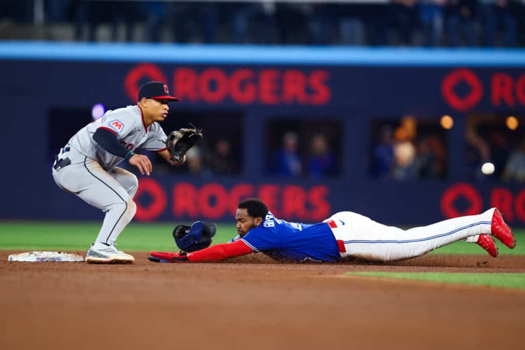 TORONTO, CANADA - APRIL 25: Vladimir Guerrero Jr. #27 of the Toronto Blue Jays slides into second base as he steals from Juan Brito #34 of the Cleveland Guardians in the sixth inning of their MLB game at Rogers Centre on April 25, 2026 in Toronto, Ontario, Canada.