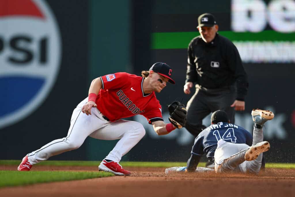 CLEVELAND, OHIO - APRIL 28: Travis Bazzana #37 of the Cleveland Guardians covers as Chandler Simpson #14 of the Tampa Bay Rays steals second base during the third inning of Bazzana's Major League debut at Progressive Field on April 28, 2026 in Cleveland, Ohio.