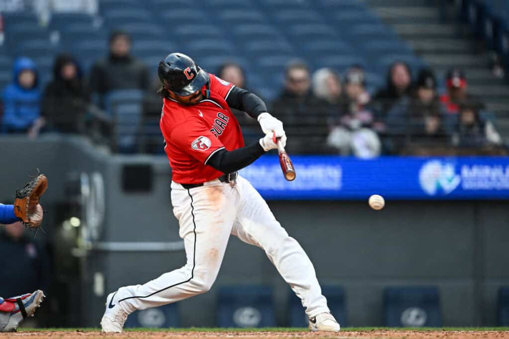 CLEVELAND, OHIO - APRIL 05: Austin Hedges #27 of the Cleveland Guardians hits an RBI single during the eighth inning in game two of a doubleheader against the Chicago Cubs at Progressive Field on April 05, 2026 in Cleveland, Ohio.