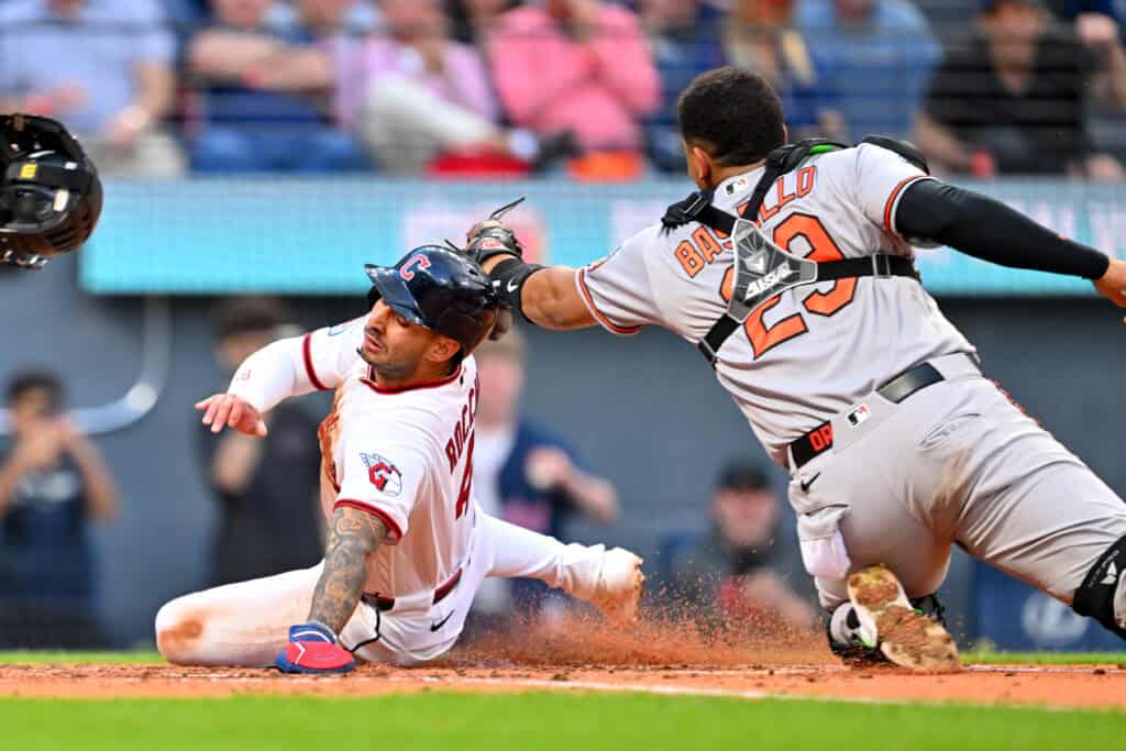 CLEVELAND, OHIO - APRIL 16: Brayan Rocchio #4 of the Cleveland Guardians scores as catcher Blaze Alexander #23 of the Baltimore Orioles misses the tag during the fifth inning at Progressive Field on April 16, 2026 in Cleveland, Ohio.