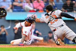 CLEVELAND, OHIO - APRIL 16: Brayan Rocchio #4 of the Cleveland Guardians scores as catcher Blaze Alexander #23 of the Baltimore Orioles misses the tag during the fifth inning at Progressive Field on April 16, 2026 in Cleveland, Ohio.
