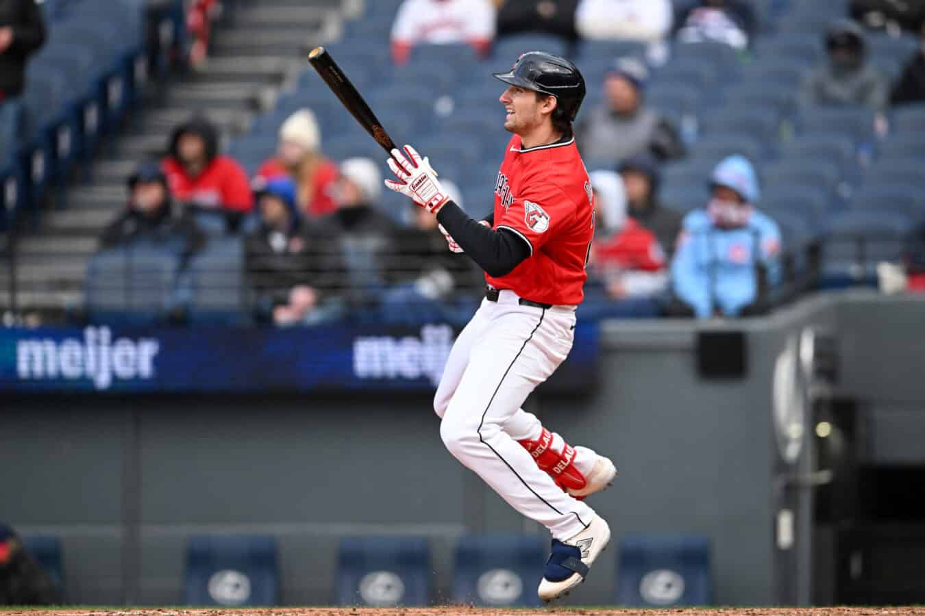 CLEVELAND, OHIO - APRIL 05: Chase DeLauter #24 of the Cleveland Guardians hits an RBI sacrifice fly ball during the sixth inning in game two of a doubleheader against the Chicago Cubs at Progressive Field on April 05, 2026 in Cleveland, Ohio.