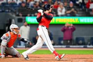 CLEVELAND, OHIO - APRIL 21: Chase DeLauter #24 of the Cleveland Guardians hits a three-run triple during the eighth inning against the Houston Astros at Progressive Field on April 21, 2026, in Cleveland, Ohio. The Guardians defeated the Astros 5-8.