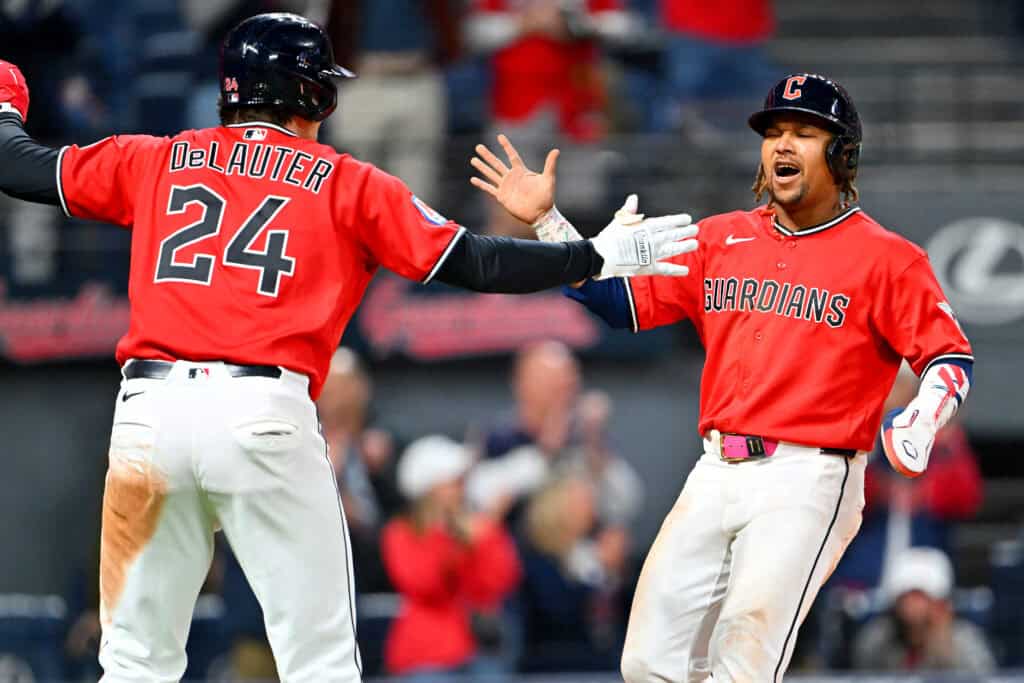 CLEVELAND, OHIO - APRIL 21: Chase DeLauter #24 and José Ramírez #11 of the Cleveland Guardians celebrate scoring during the eighth inning against the Houston Astros at Progressive Field on April 21, 2026 in Cleveland, Ohio. The Guardians defeated the Astros 5-8.
