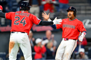 CLEVELAND, OHIO - APRIL 21: Chase DeLauter #24 and José Ramírez #11 of the Cleveland Guardians celebrate scoring during the eighth inning against the Houston Astros at Progressive Field on April 21, 2026 in Cleveland, Ohio. The Guardians defeated the Astros 5-8.