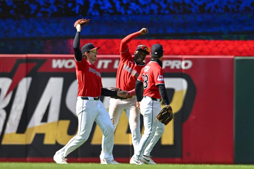 CLEVELAND, OHIO - APRIL 08: Chase DeLauter #24, Angel Martínez #1 and Steven Kwan #38 of the Cleveland Guardians celebrate the team's 10-2 win over the Kansas City Royals at Progressive Field on April 08, 2026 in Cleveland, Ohio.