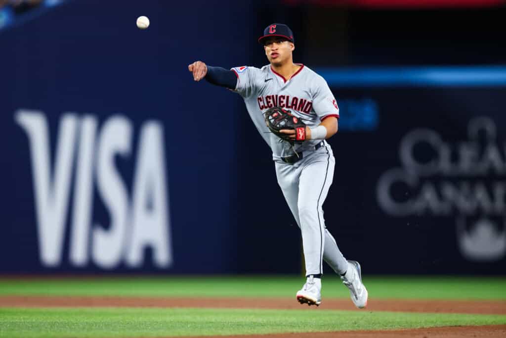 TORONTO, CANADA - APRIL 25: Juan Brito #34 of the Cleveland Guardians makes a throw to first to tag out Eloy Jiménez #74 of the Toronto Blue Jays in the second inning inning of their MLB game against the Cleveland Guardians at Rogers Centre on April 25, 2026 in Toronto, Ontario, Canada.