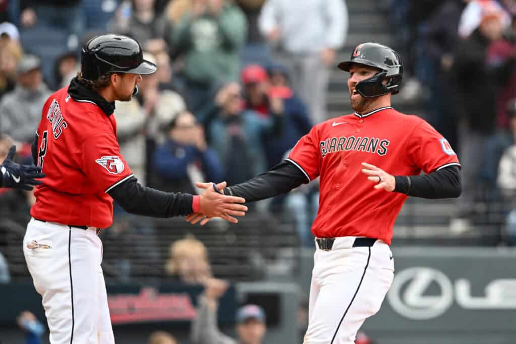 CLEVELAND, OHIO - APRIL 19: Rhys Hoskins #8 and David Fry #6 of the Cleveland Guardians celebrate scoring on a single hit by Brayan Rocchio during the eighth inning against the Baltimore Orioles at Progressive Field on April 19, 2026 in Cleveland, Ohio