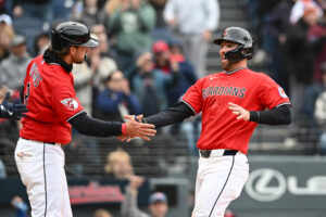 CLEVELAND, OHIO - APRIL 19: Rhys Hoskins #8 and David Fry #6 of the Cleveland Guardians celebrate scoring on a single hit by Brayan Rocchio during the eighth inning against the Baltimore Orioles at Progressive Field on April 19, 2026 in Cleveland, Ohio