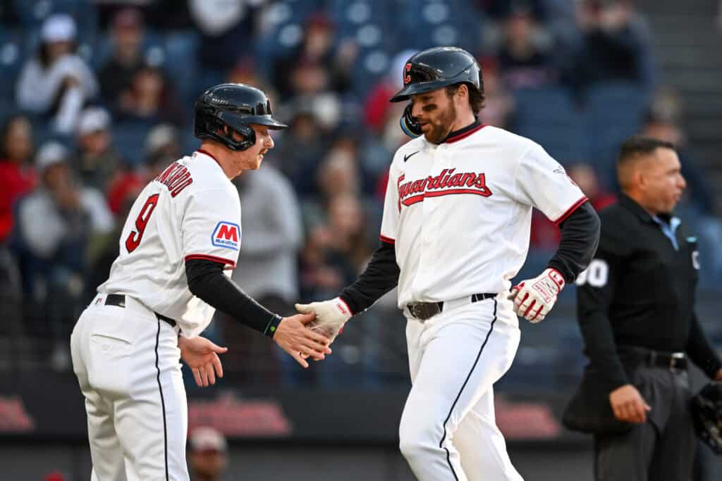 CLEVELAND, OHIO - MAY 11: Kyle Manzardo #9 and Daniel Schneemann #10 of the Cleveland Guardians celebrate scoring on a single hit by teammate Brayan Rocchio #4 (not pictured) during the second inning against the Los Angeles Angels at Progressive Field on May 11, 2026 in Cleveland, Ohio.