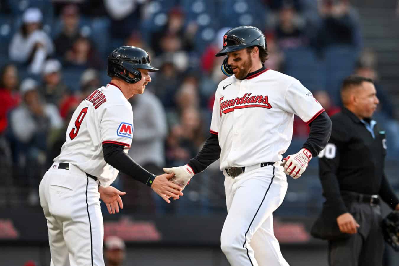 CLEVELAND, OHIO - MAY 11: Kyle Manzardo #9 and Daniel Schneemann #10 of the Cleveland Guardians celebrate scoring on a single hit by teammate Brayan Rocchio #4 (not pictured) during the second inning against the Los Angeles Angels at Progressive Field on May 11, 2026 in Cleveland, Ohio.
