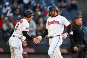 CLEVELAND, OHIO - MAY 11: Kyle Manzardo #9 and Daniel Schneemann #10 of the Cleveland Guardians celebrate scoring on a single hit by teammate Brayan Rocchio #4 (not pictured) during the second inning against the Los Angeles Angels at Progressive Field on May 11, 2026 in Cleveland, Ohio.