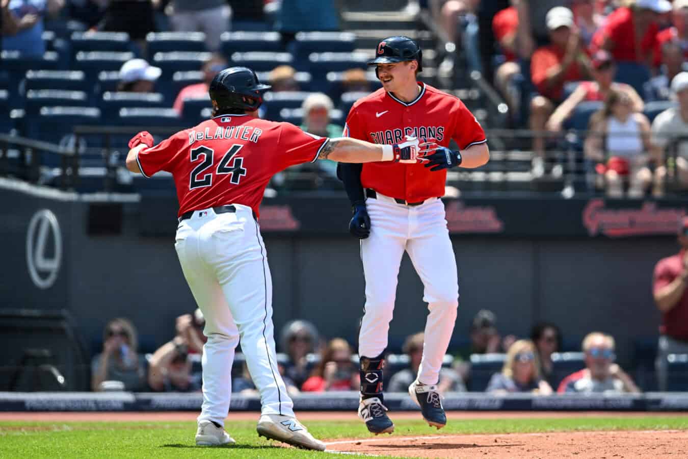 CLEVELAND, OHIO - MAY 17: Chase DeLauter #24 and Kyle Manzardo #9 of the Cleveland Guardians celebrate a two-run home run that was hit by Manzardo during the third inning against the Cincinnati Reds at Progressive Field on May 17, 2026 in Cleveland, Ohio. (Photo by Nick