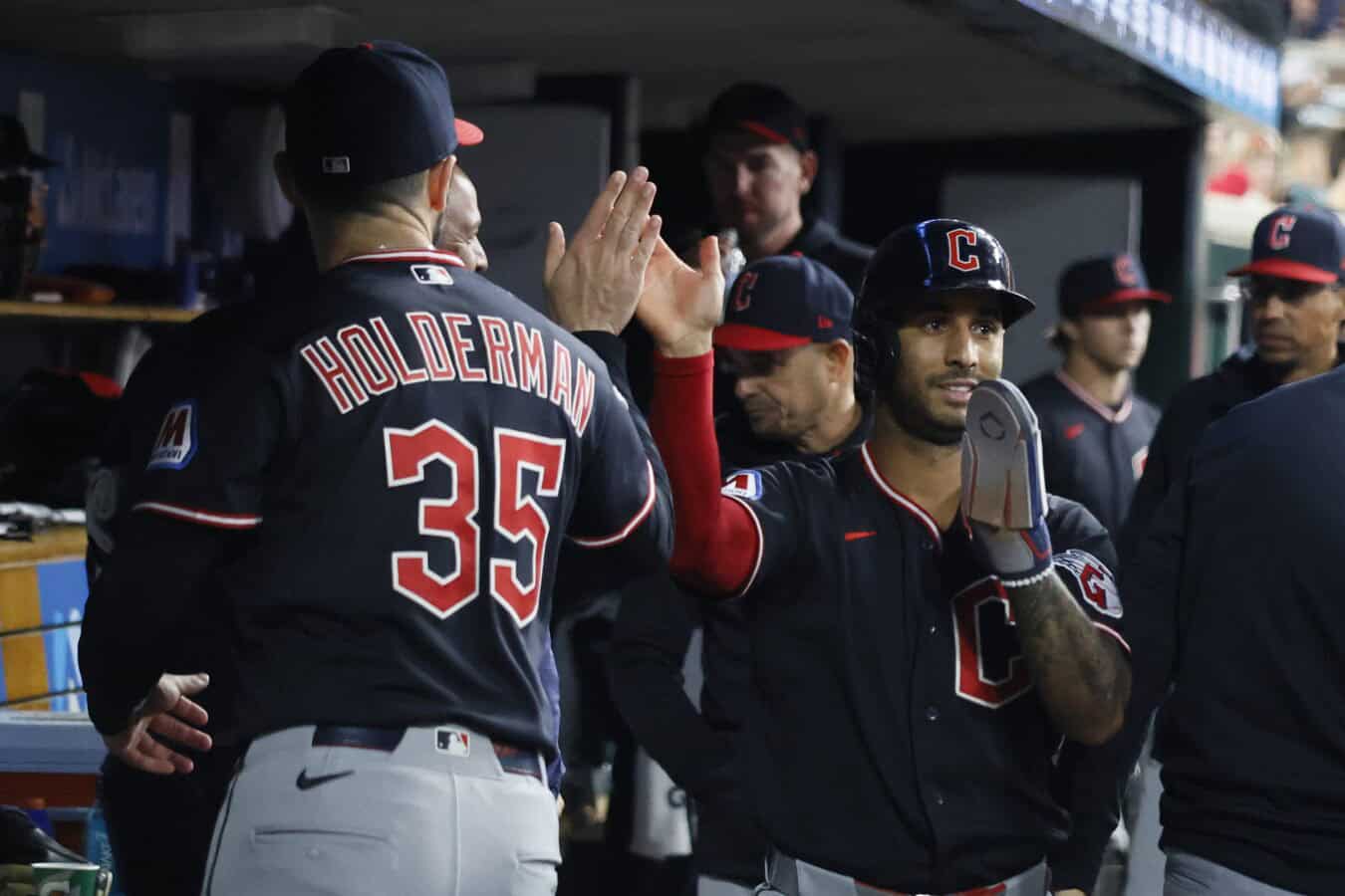 DETROIT, MI - MAY 20: Brayan Rocchio #4 of the Cleveland Guardians celebrates scoring the go-ahead run with Colin Holderman #35 in the 10th inning against the Detroit Tigers at Comerica Park on May 20, 2026 in Detroit, Michigan.