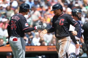 DETROIT, MICHIGAN - MAY 21: Daniel Schneemann #10 of the Cleveland Guardians celebrates scorig a run in the third inning with Chase DeLauter in front of Dillon Dingler #13 of the Detroit Tigers at Comerica Park on May 21, 2026 in Detroit, Michigan.