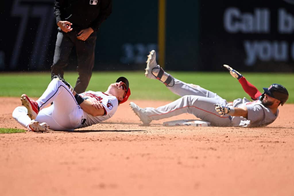 CLEVELAND, OHIO - MAY 31: Travis Bazzana #37 of the Cleveland Guardians grabs his arm after tagging out Wilyer Abreu #52 of the Boston Red Sox at second base during the fifth inning at Progressive Field on May 31, 2026 in Cleveland, Ohio.
