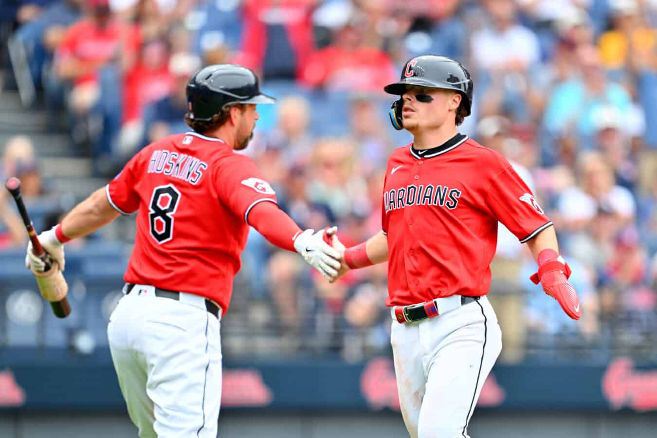 CLEVELAND, OHIO - MAY 27: Rhys Hoskins #8 celebrates with Travis Bazzana #37 of the Cleveland Guardians after Bazzana scored during the fifth inning against the Washington Nationals at Progressive Field on May 27, 2026 in Cleveland, Ohio.