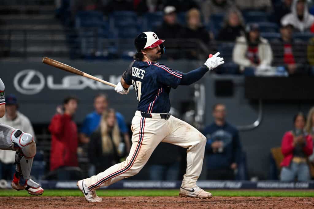 CLEVELAND, OHIO - MAY 08: Austin Hedges #27 of the Cleveland Guardians hits an RBI infield single during the eighth inning against the Minnesota Twins at Progressive Field on May 08, 2026 in Cleveland, Ohio.