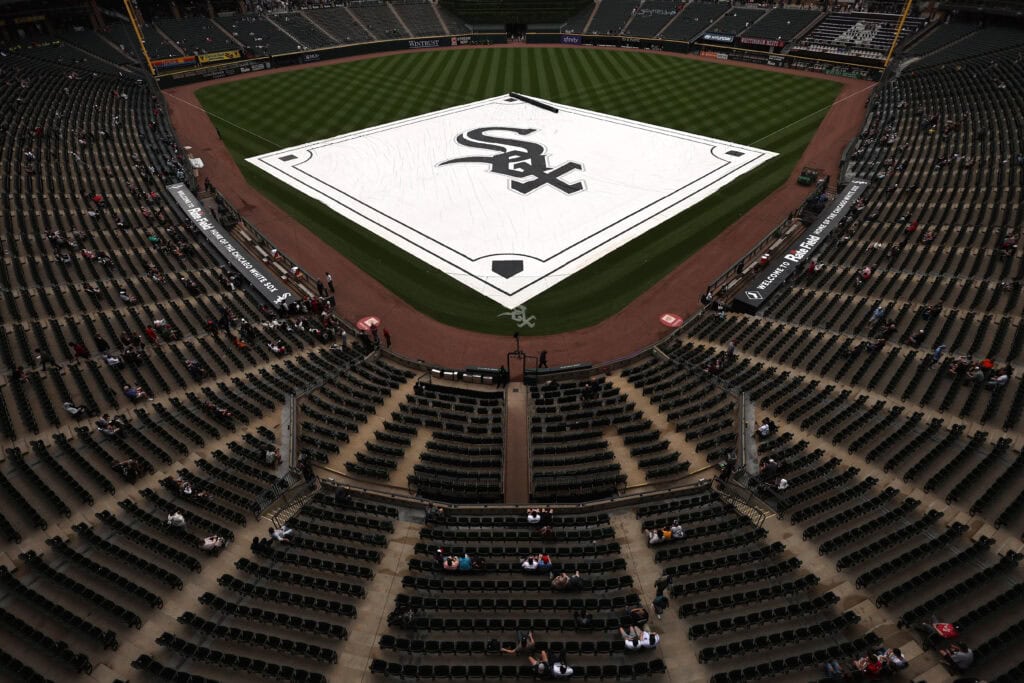 CHICAGO, ILLINOIS - JUNE 24: The tarp is pulled over the diamond during a rain delay before a game between the Cleveland Guardians and the Chicago White Sox at Rate Field on June 24, 2026 in Chicago, Illinois.