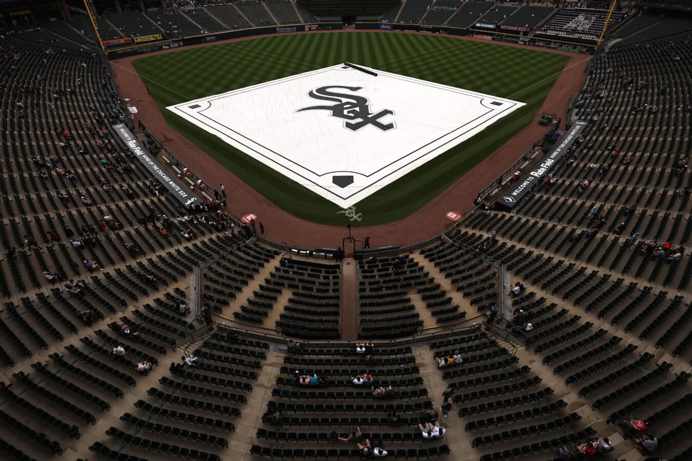CHICAGO, ILLINOIS - JUNE 24: The tarp is pulled over the diamond during a rain delay before a game between the Cleveland Guardians and the Chicago White Sox at Rate Field on June 24, 2026 in Chicago, Illinois.