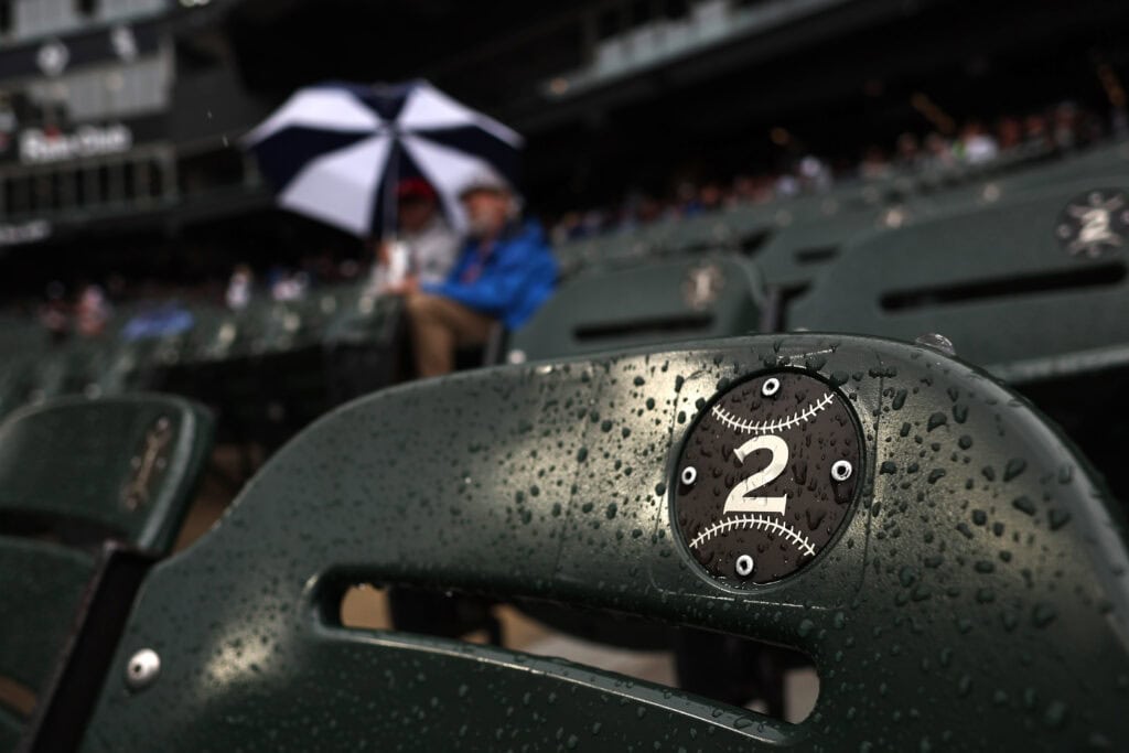 CHICAGO, ILLINOIS - JUNE 24: Fans wait under an umbrella during a rain delay in the game between the Cleveland Guardians and the Chicago White Sox at Rate Field on June 24, 2026 in Chicago, Illinois.