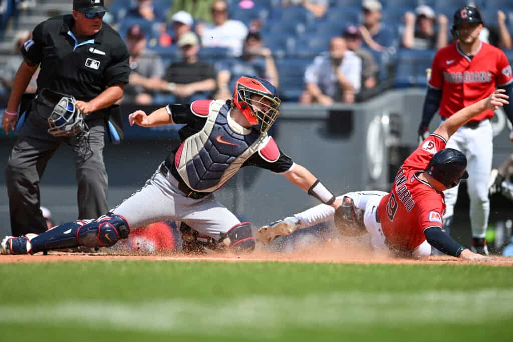CLEVELAND, OHIO - JULY 05: Kyle Manzardo #9 of the Cleveland Guardians beats the tag by Kyle Teel #8 of the Chicago White Sox to score on a single hit by Daniel Schneemann (not pictured) during the first inning at Progressive Field on July 05, 2026 in Cleveland, Ohio.