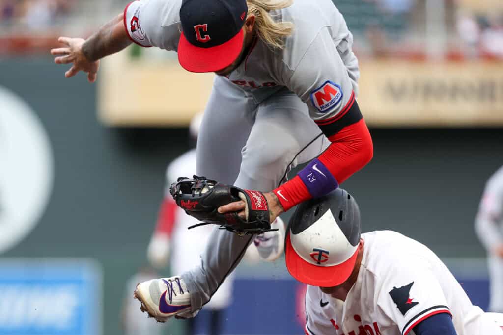 MINNEAPOLIS, MINNESOTA - JULY 8: Gabriel Arias #13 of the Cleveland Guardians tags out Brooks Lee #22 of the Minnesota Twins on a pickoff play at third base during the first inning at Target Field on July 8, 2026 in Minneapolis, Minnesota.