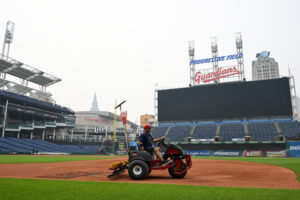 CLEVELAND, OHIO - JULY 17: A member of the Cleveland Guardians grounds crew rakes the field as the game against the Pittsburgh Pirates was postponed due to air quality at Progressive Field on July 17, 2026 in Cleveland, Ohio.