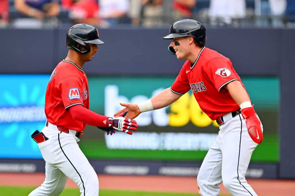CLEVELAND, OHIO - JULY 20: (L-R) Brayan Rocchio #4 of the Cleveland Guardians celebrates with Travis Bazzana #37 after both scored on the home run by Rocchio during the first inning against the Minnesota Twins at Progressive Field on July 20, 2026 in Cleveland, Ohio.