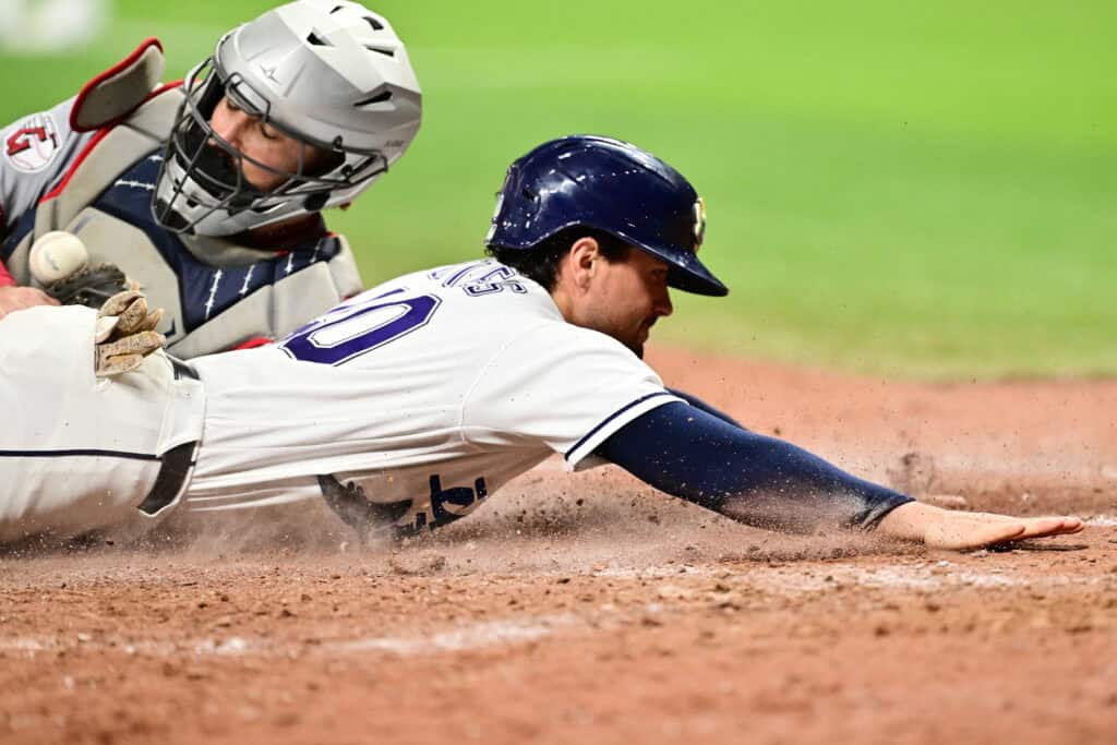 ST PETERSBURG, FLORIDA - JULY 24: Nick Fortes #40 of the Tampa Bay Rays slides home to score on an error by Austin Hedges #27 of the Cleveland Guardians in the sixth inning at Tropicana Field on July 24, 2026 in St Petersburg, Florida.